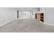 Expansive finished basement featuring neutral carpet, built-in shelves, and plenty of natural light at 6427 S Tibet St, Aurora, CO 80016
