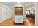 Hallway with hardwood floors, a storage cabinet, and an office on the side at 6427 S Tibet St, Aurora, CO 80016