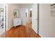 Inviting hallway featuring hardwood floors, neutral paint, and stylish decor at 6427 S Tibet St, Aurora, CO 80016