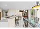 Bright kitchen and dining area with bar seating and access to outdoor deck at 6427 S Tibet St, Aurora, CO 80016