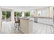 Bright and airy kitchen with stainless steel appliances, white cabinetry and breakfast bar at 6427 S Tibet St, Aurora, CO 80016