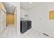Convenient laundry room features modern washer and dryer, tile floor and white cabinetry at 6427 S Tibet St, Aurora, CO 80016