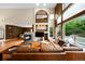 Stylish living room featuring a fireplace, large windows, and a comfortable leather sofa at 6427 S Tibet St, Aurora, CO 80016
