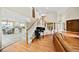 Spacious living room with hardwood floors, staircase, and views into the kitchen and dining areas at 6427 S Tibet St, Aurora, CO 80016