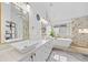 Spa-like primary bathroom with double vanities, soaking tub, and modern fixtures at 6427 S Tibet St, Aurora, CO 80016