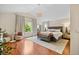 Spacious main bedroom features wood floors, a chandelier, and a seating area at 6427 S Tibet St, Aurora, CO 80016