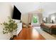 Spacious main bedroom features wood floors, a large TV, and a seating area at 6427 S Tibet St, Aurora, CO 80016