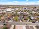 Aerial view of a suburban neighborhood with commercial buildings in the background at 6640 Grove St, Denver, CO 80221