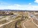 Aerial image showing a park, walking paths, and a train station in a suburban area at 6640 Grove St, Denver, CO 80221