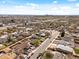 An aerial view of homes in a suburban neighborhood, with the city skyline in the distance at 6640 Grove St, Denver, CO 80221