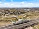 An aerial view featuring a train station, a bridge, a park, and mountain views at 6640 Grove St, Denver, CO 80221