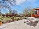 Large backyard featuring a patio with a picnic table, blooming trees, and a well-maintained lawn at 6640 Grove St, Denver, CO 80221