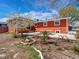 A beautiful orange house featuring a spacious backyard and patio area at 6640 Grove St, Denver, CO 80221