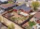 Aerial view of fenced backyard with fire pit, patio, garden and storage shed at 6640 Grove St, Denver, CO 80221