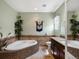 Bright bathroom featuring a soaking tub, double vanity, and stylish fixtures at 6640 Grove St, Denver, CO 80221