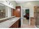 Bathroom with sink, granite countertop, and a view into the bedroom at 6640 Grove St, Denver, CO 80221