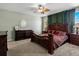 Elegantly furnished bedroom with a luxurious wooden bed frame and matching furniture at 6640 Grove St, Denver, CO 80221