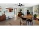 Dining room featuring wood floors, a stylish ceiling fan, views to the kitchen, and an adjacent living area at 6640 Grove St, Denver, CO 80221