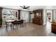 Open-concept dining room with hardwood floors, ample natural light, and stylish décor leading to a front entryway at 6640 Grove St, Denver, CO 80221