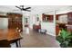Inviting dining area with wooden floors, stylish rug, and antique cabinet, seamlessly flowing into an open kitchen at 6640 Grove St, Denver, CO 80221