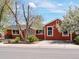 Charming single-story home with a brick-red exterior, well-maintained lawn and driveway at 6640 Grove St, Denver, CO 80221