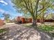 Charming home with a large tree in the yard and an inviting front porch at 6640 Grove St, Denver, CO 80221