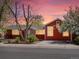 Charming home featuring a well-manicured front yard, mature trees, and a welcoming entrance during a beautiful sunset at 6640 Grove St, Denver, CO 80221