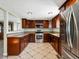Well-equipped kitchen with stainless steel appliances, granite countertops, and rich wooden cabinetry, creating a functional cooking space at 6640 Grove St, Denver, CO 80221