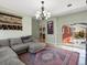 Comfortable living room with ample seating, decorative rug, and sliding door access to the back patio for easy outdoor flow at 6640 Grove St, Denver, CO 80221