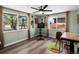 Bright home office with hardwood floors, a ceiling fan, and two large windows providing ample natural light at 6640 Grove St, Denver, CO 80221