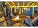Cozy backyard with a charming fire pit, comfortable seating, and atmospheric string lights overhead at 920 Neon Forest Cir, Longmont, CO 80504