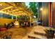 Backyard with fire pit, outdoor seating, grill, and ambient string lights for evening gatherings at 920 Neon Forest Cir, Longmont, CO 80504