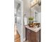 Bright bathroom featuring a stylish vessel sink, tile flooring, and modern lighting at 920 Neon Forest Cir, Longmont, CO 80504