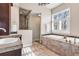 Luxurious bathroom showcasing a soaking tub, separate shower, and elegant tile work at 920 Neon Forest Cir, Longmont, CO 80504