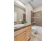 Well-lit bathroom featuring a tub/shower, vanity with sink, and tile flooring at 920 Neon Forest Cir, Longmont, CO 80504