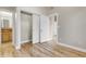 Bright bedroom features beautiful hardwood floors, closet, and doorway to bathroom and hallway at 920 Neon Forest Cir, Longmont, CO 80504