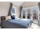 Bedroom featuring a plush bed, natural light, and French doors leading to an outdoor area at 920 Neon Forest Cir, Longmont, CO 80504