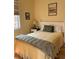 Cozy bedroom with a white wood bed frame and side table with lamp at 920 Neon Forest Cir, Longmont, CO 80504