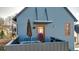 Deck with an umbrella, a table and chairs and the home's unique blue exterior at 920 Neon Forest Cir, Longmont, CO 80504