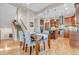 Open dining area featuring a staircase, modern pendant lighting, and seamless access to the kitchen with stainless appliances at 920 Neon Forest Cir, Longmont, CO 80504