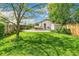 Well-maintained backyard with patio seating, storage shed, and mature trees for shade at 3625 W 9Th Ave, Denver, CO 80204