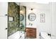 Modern bathroom with green tiled shower, stylish vanity and natural light from skylight at 3625 W 9Th Ave, Denver, CO 80204
