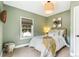 Relaxing bedroom featuring soft lighting, neutral tones, and a comfortable full bed with a view to the outside at 3625 W 9Th Ave, Denver, CO 80204