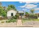 Inviting single-story home with a picket fence, walkway, garden, and lush landscaping at 3625 W 9Th Ave, Denver, CO 80204