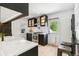 Stylish kitchen features stainless steel appliances, white countertops, a farmhouse sink, and a cozy dining area at 3625 W 9Th Ave, Denver, CO 80204