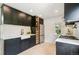 Modern kitchen features dark cabinets, stainless steel appliances, white countertops, and a farmhouse sink at 3625 W 9Th Ave, Denver, CO 80204