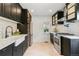 Modern kitchen featuring black cabinets, white countertops, subway tile backsplash, and stainless steel appliances at 3625 W 9Th Ave, Denver, CO 80204