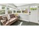 Bright sunroom featuring tiled floors, a comfortable sofa, and multiple windows at 3625 W 9Th Ave, Denver, CO 80204