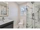 Modern bathroom with marble backsplash and glass enclosed shower at 4385 Carr St, Wheat Ridge, CO 80033