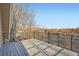 This outdoor deck features wood flooring and rod iron railing with landscape views at 4385 Carr St, Wheat Ridge, CO 80033